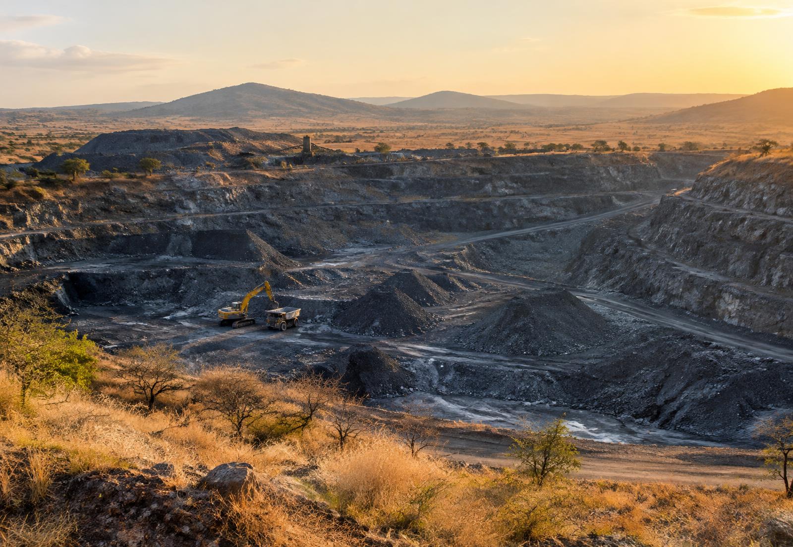 Terraced open-pit mine in dry savanna at sunset